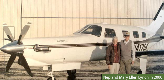 Background: Nep and Mary Ellen in front of an airplane - Caption: Nep and Mary Ellen Lynch in 2000
