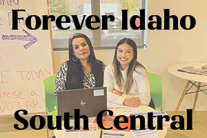 Background: Two women sitting at a table with paperwork in front of them. Caption: Forever Idaho South Central